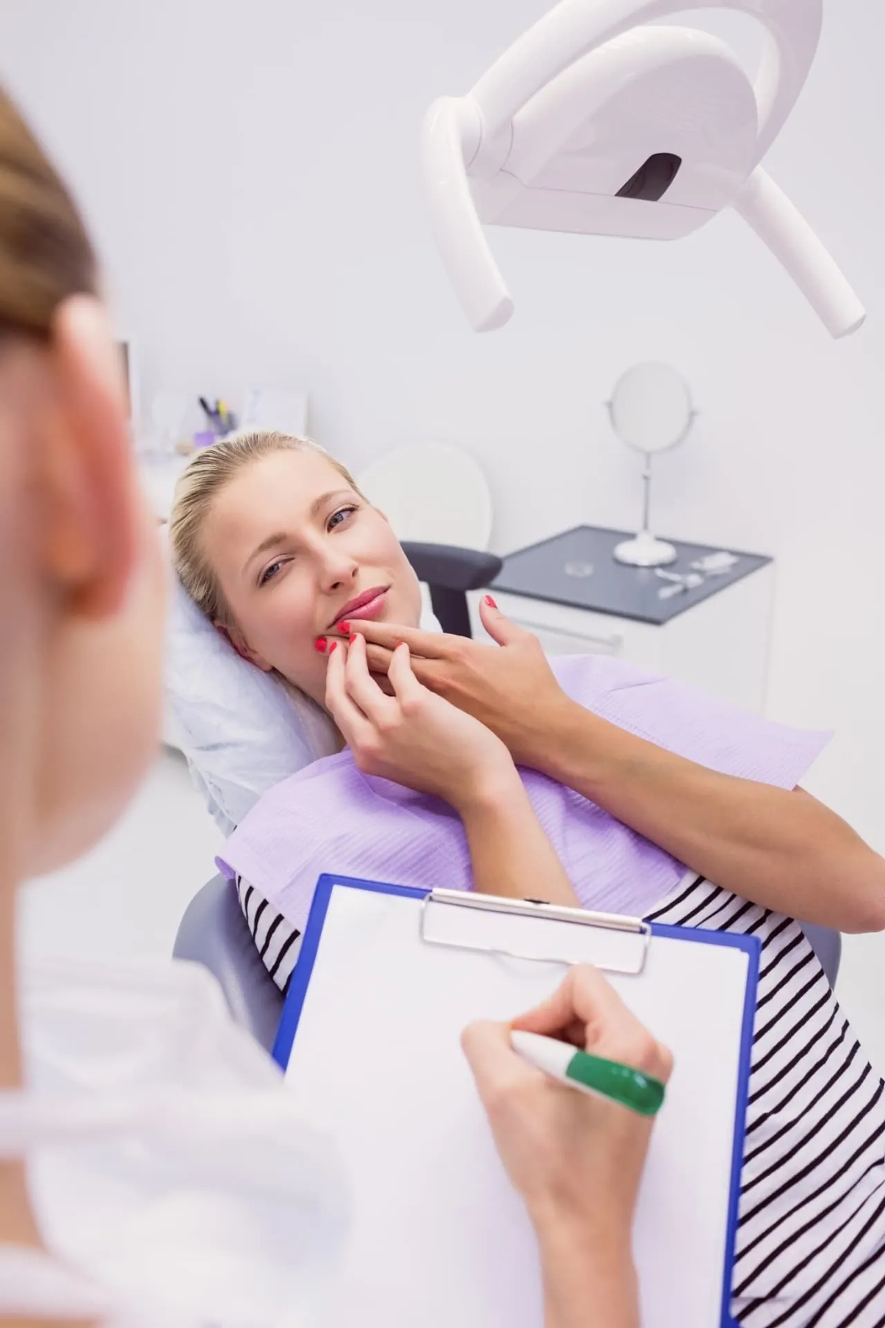 Dentist talking with a patient before a tooth extraction