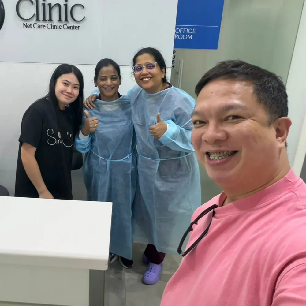 Our team and a patient at the Net Dental Clinic reception