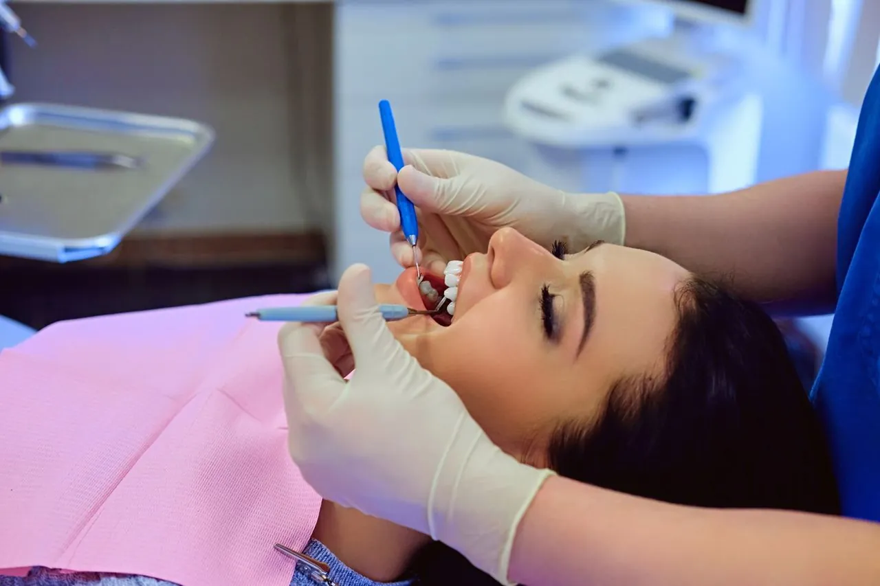 Dentist cleaning a patient's teeth during a check-up